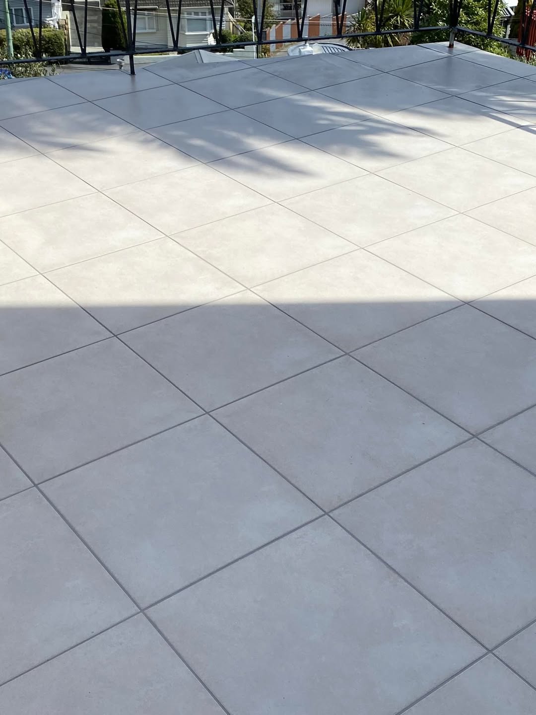 After restoration: outdoor tiled area cleaned with defined grout lines